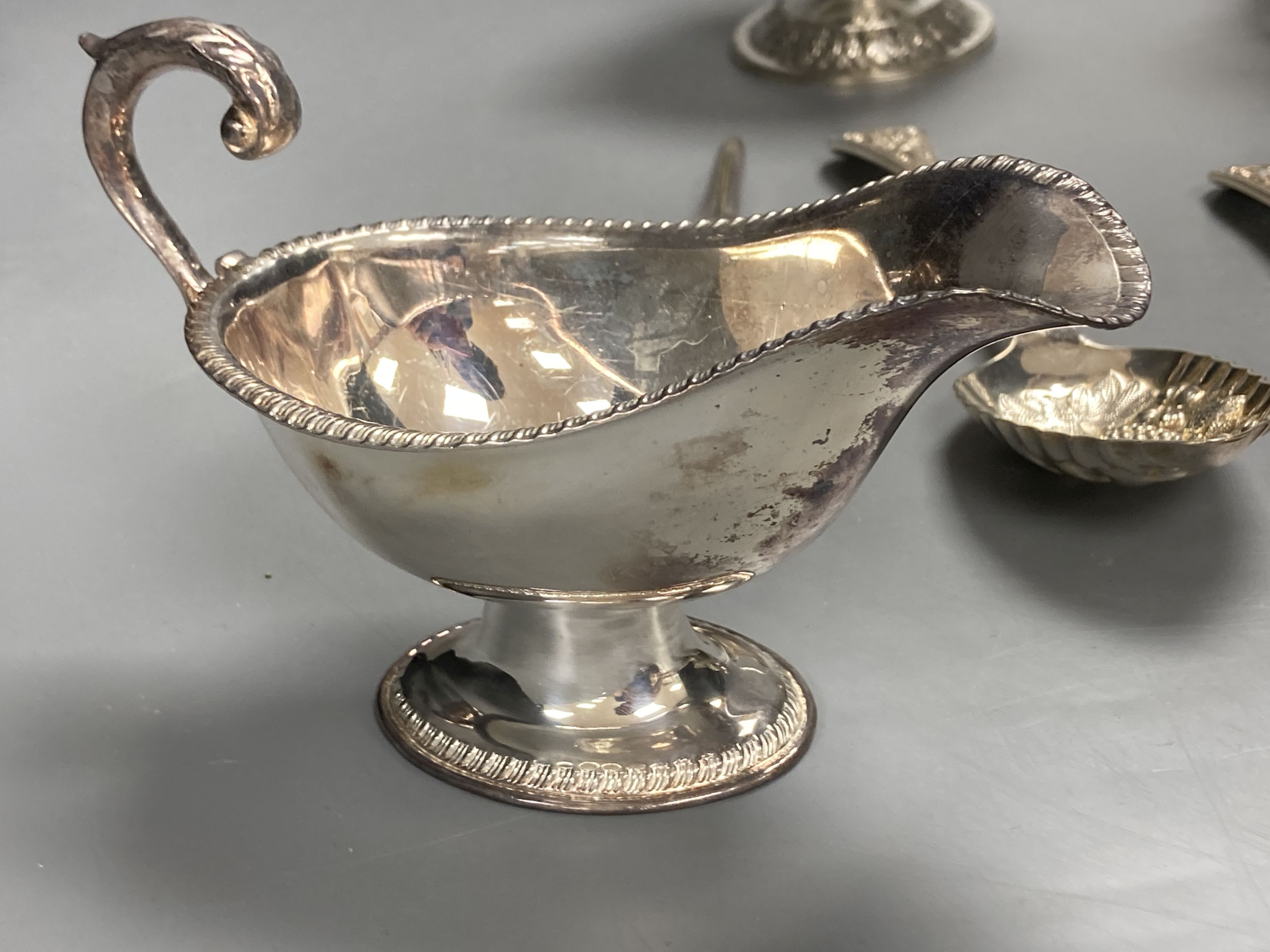 A sterling mug, a silver bonbon dish, a white metal strainer and a group of minor plated items.